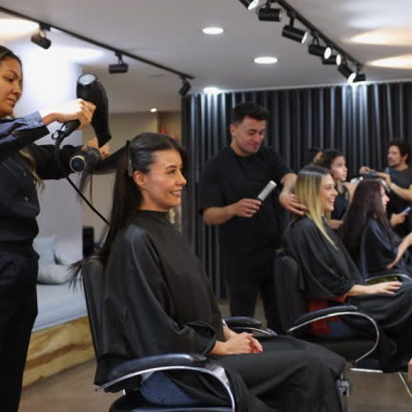 Customers at the beauty salon getting different hair cuts and beauty treatments - Beauty and lifestyles concepts