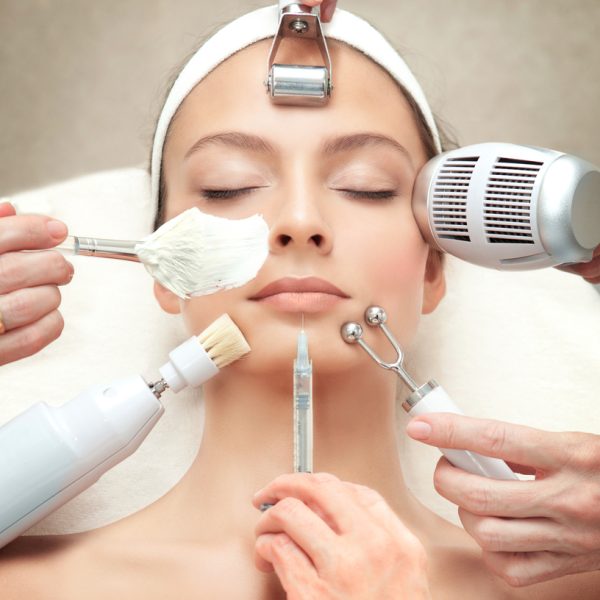 Spa Salon: Young Beautiful Woman Having Different Facial Treatment